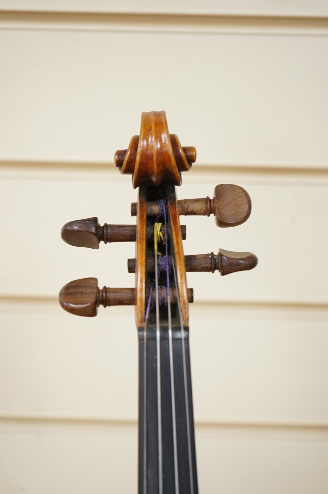 Three cased violins; a German Dresden violin, supplied by Campbell and co., Glasgow, together with another Dresden Stradivarius copy, and the remains of a European violin.